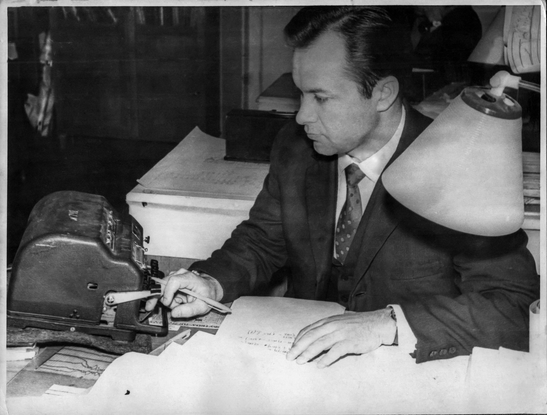 Retro photo of a young bookkeeper and accountant making calculations on client books. Accountant and bookkeeper. Accounting, Bookkeeping, small business, accounts receivable, accounts payable. In Mesa Arizona, Tempe Arizona, Chandler Arizona, Phoenix Arizona, Gilbert Arizona